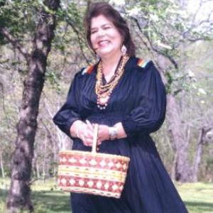 Photo of Wilma Mankiller holding a basket