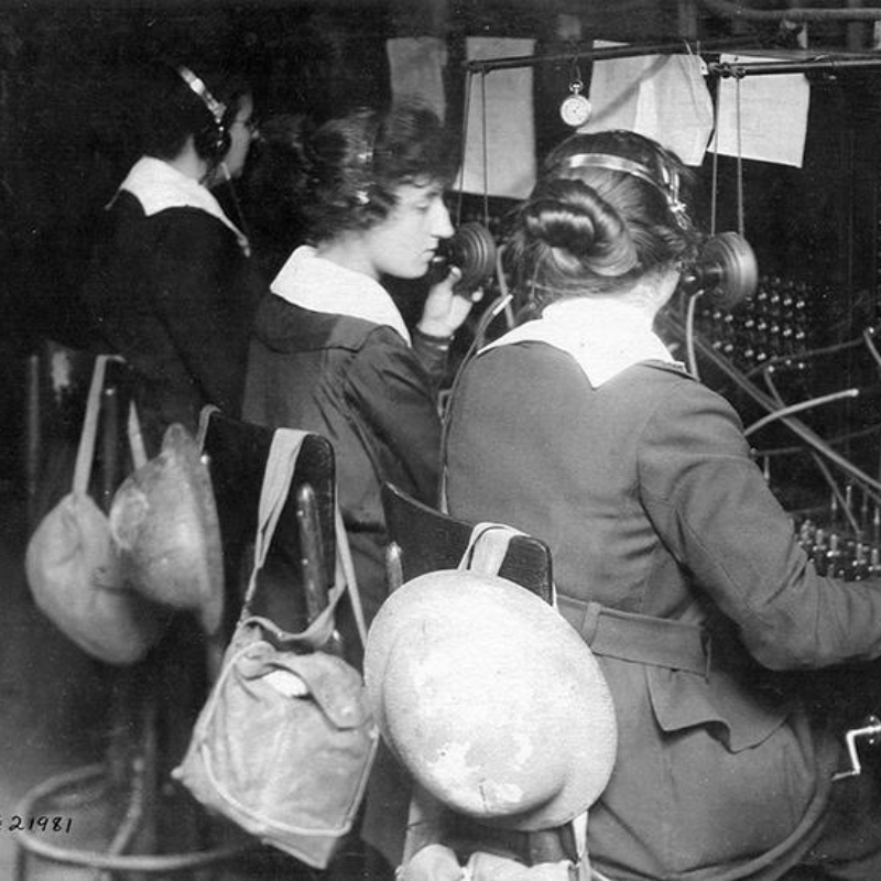 Grace Banker, Esther "Tootsie" Fresnel, and Berthe Hunt operate switchboards at the Battle of St. Michel with their trench helmets and gas masks ready.