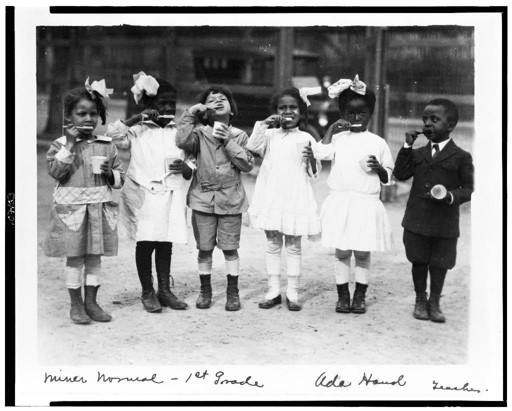 Six children brushing their teeth outside of school, Washington, D.C.